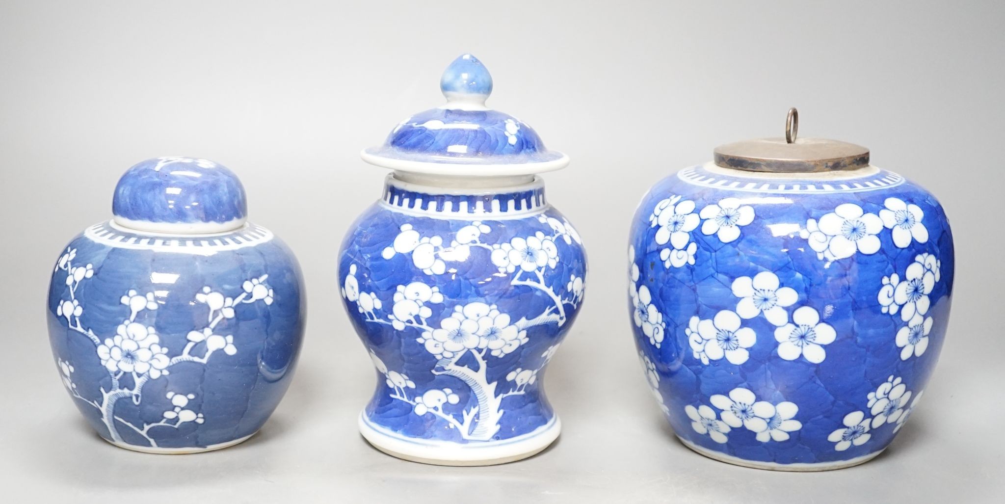 Three Chinese blue and white prunus decorated jars and covers, 19th/20th century, with four character marks 18cm